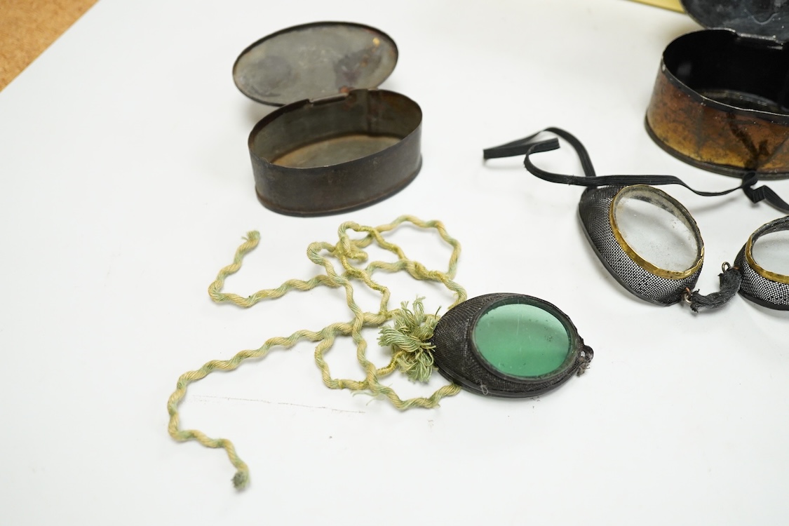 Five pairs of early 20th century goggles with mesh side protectors, two pairs colour tinted, in original tin boxes and two pairs of mesh eye protectors (7)